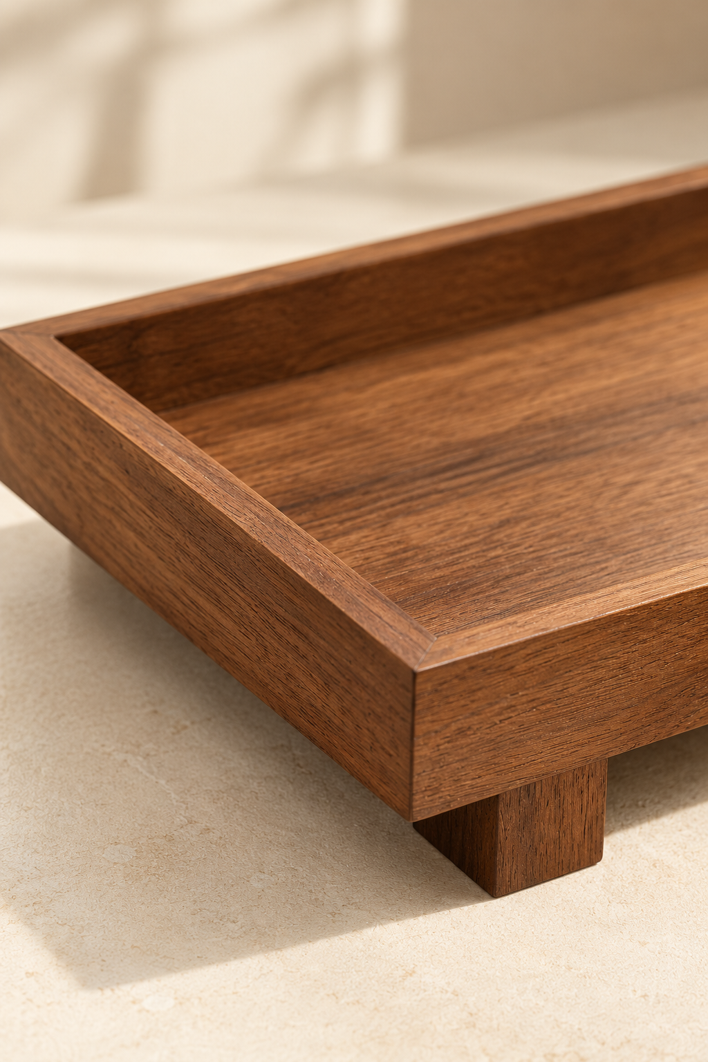 Close-up of a wooden tray corner showing the rim, wood grain and a square foot.