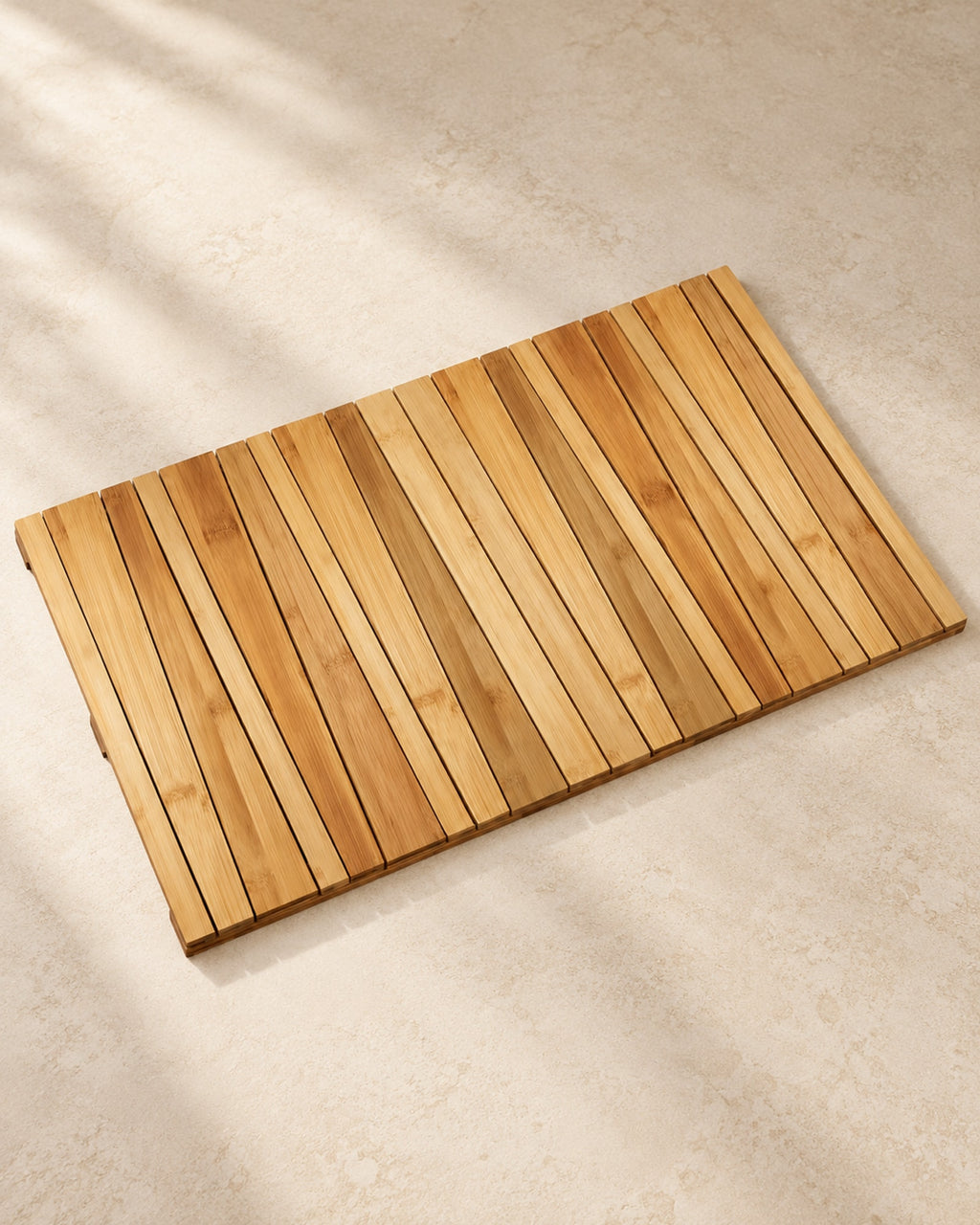 Slatted bamboo bath mat on a warm off-white floor.