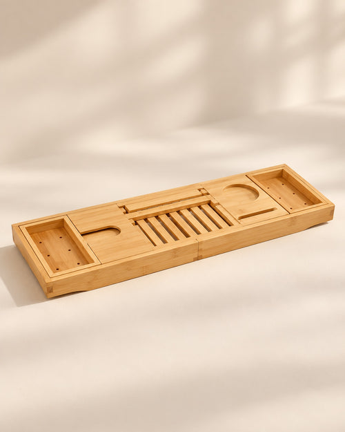 Closed bamboo bathtub caddy on a warm off-white surface.