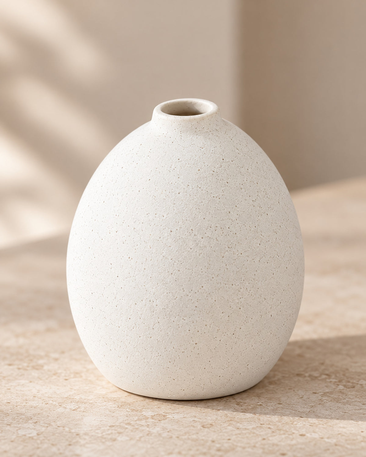 Close-up of the speckled matte surface of the round vase.