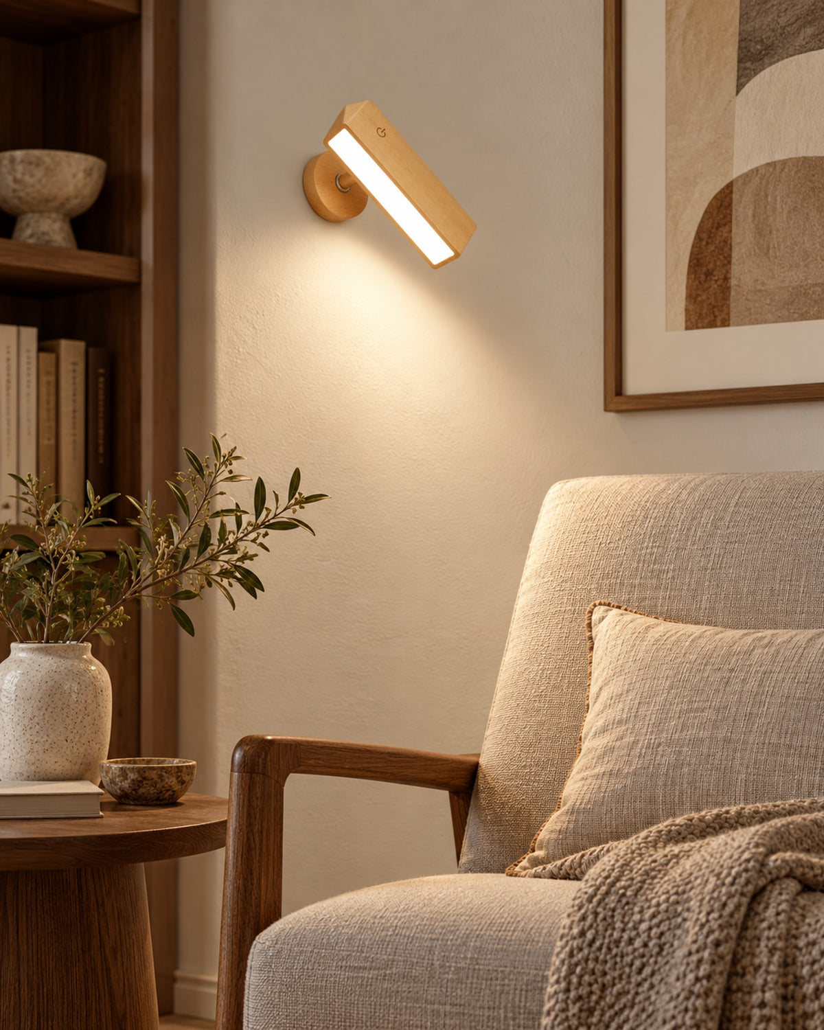 Beech wall lamp lighting a reading chair beside a bookshelf