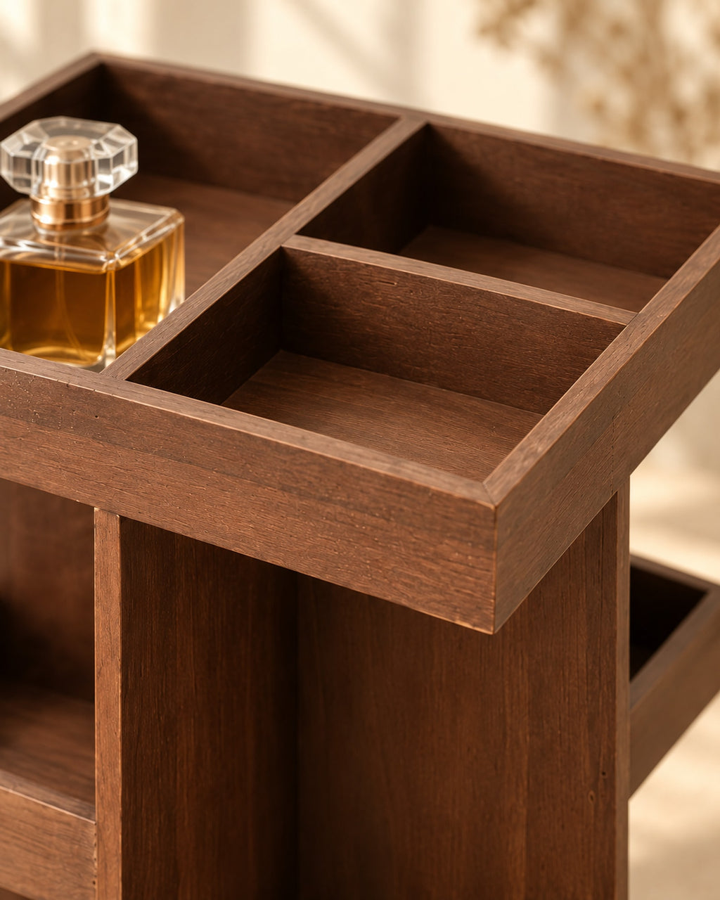 Close-up of the divided top tray of the wooden organiser, showing the wood grain and square corners.